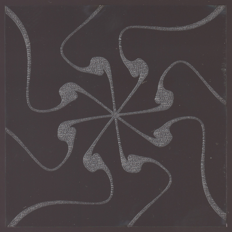 Radial pattern with eight curving lines etched on glass