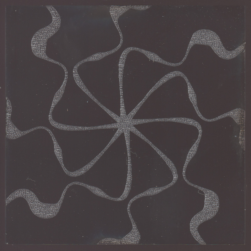 Radial pattern with eight curving lines etched on glass