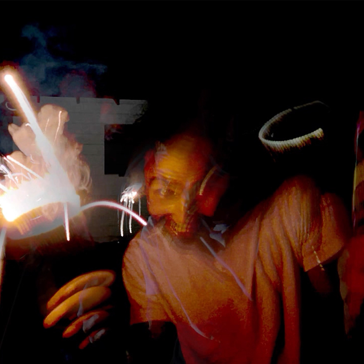 Smilling man holding fireworks